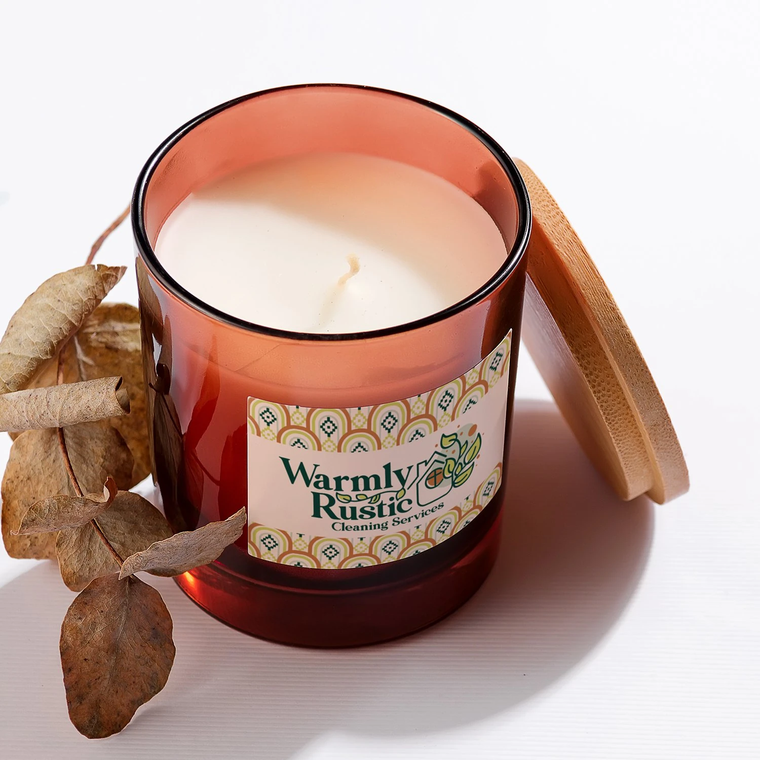 Warmly Rustic candle label on an amber jar